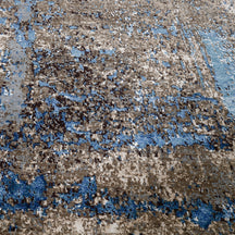 Close-up of the hand knotted wool and viscose texture with taupe slate blue charcoal and beige abstract detailing