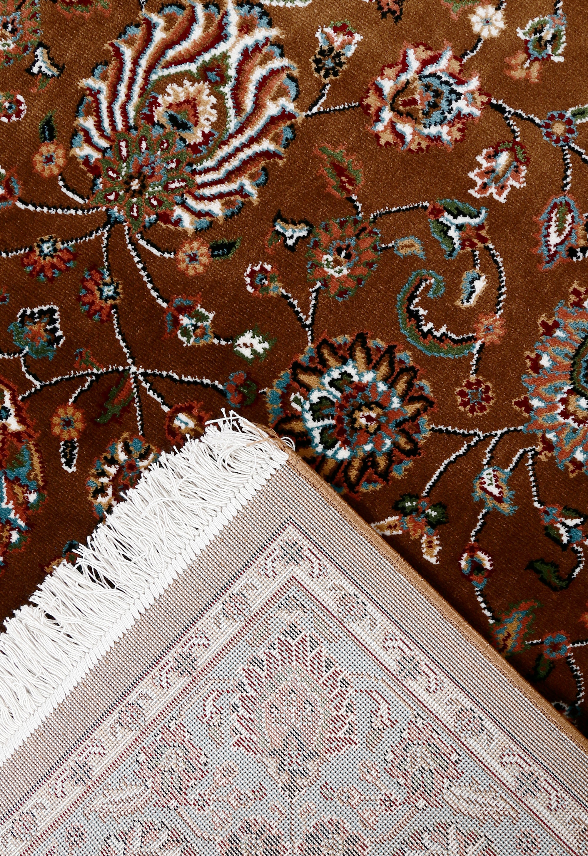 Corner and fringed edge detail of Brown Floral Machine Woven Classic Art Silk Rug with blue floral border