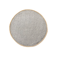 Side angle view of camel smiley face wool kids rug showing its round shape, plush 12-15 mm hand tufted pile and playful cartoon design.