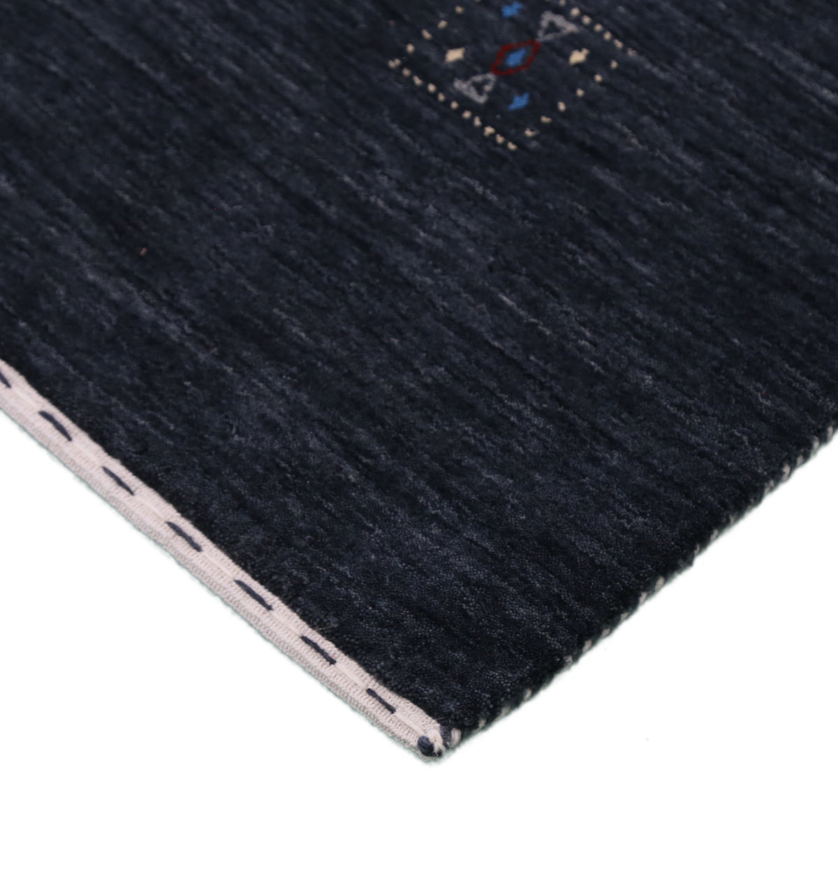 Corner and edge detail of charcoal black Hand Woven Loom Lori wool rug showing handcrafted finishing and wool texture