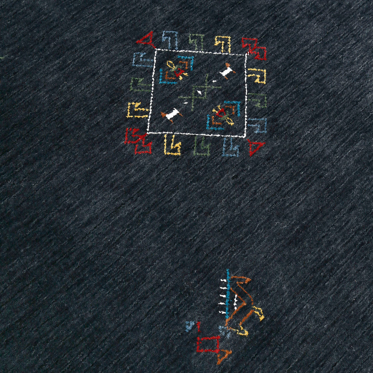 Close-up of charcoal black Hand Woven Loom Lori wool rug showing natural wool texture, diamond detailing and colourful tribal motifs
