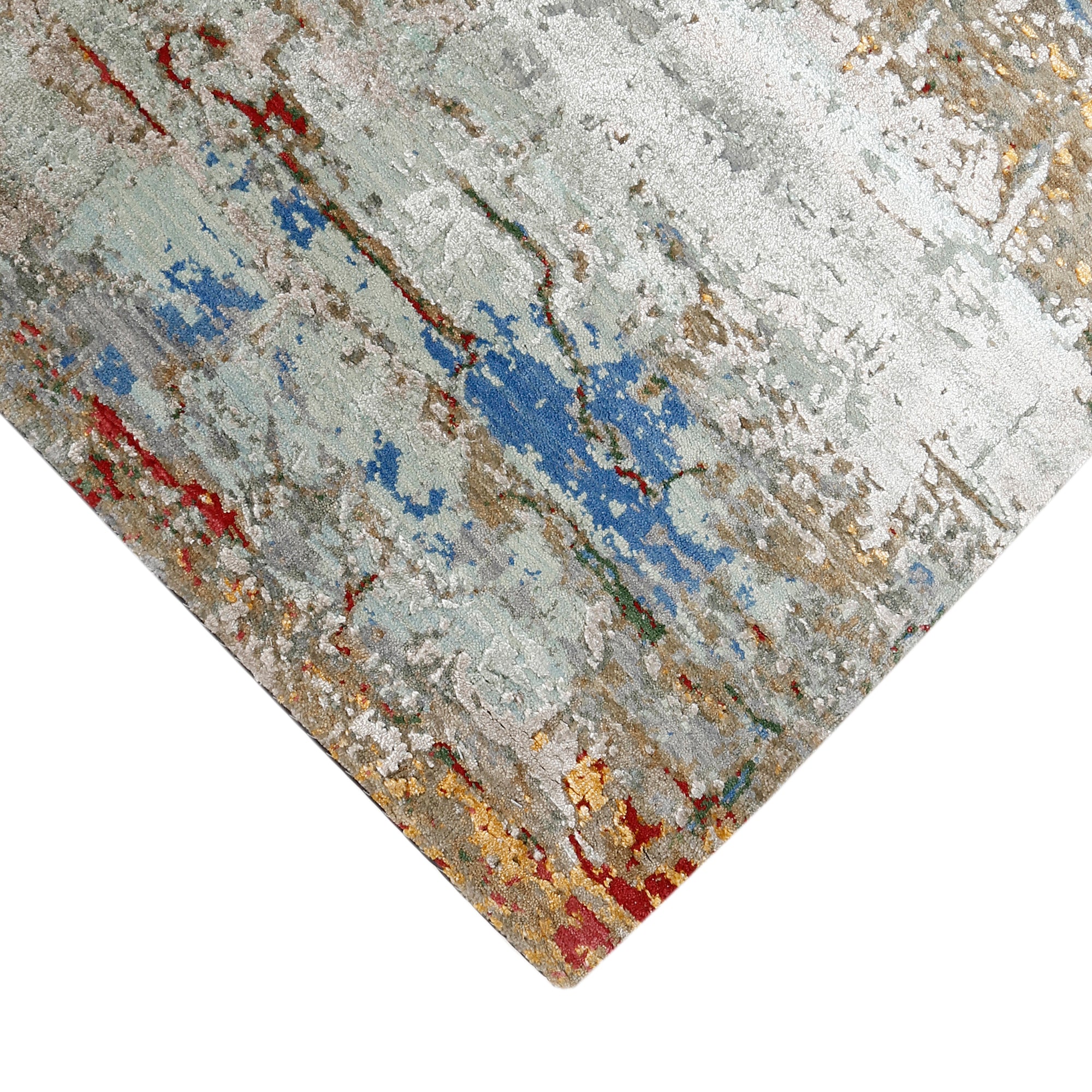 Hand-finished edge and layered distressed detailing of the cloudstone blue abstract hand knotted rug