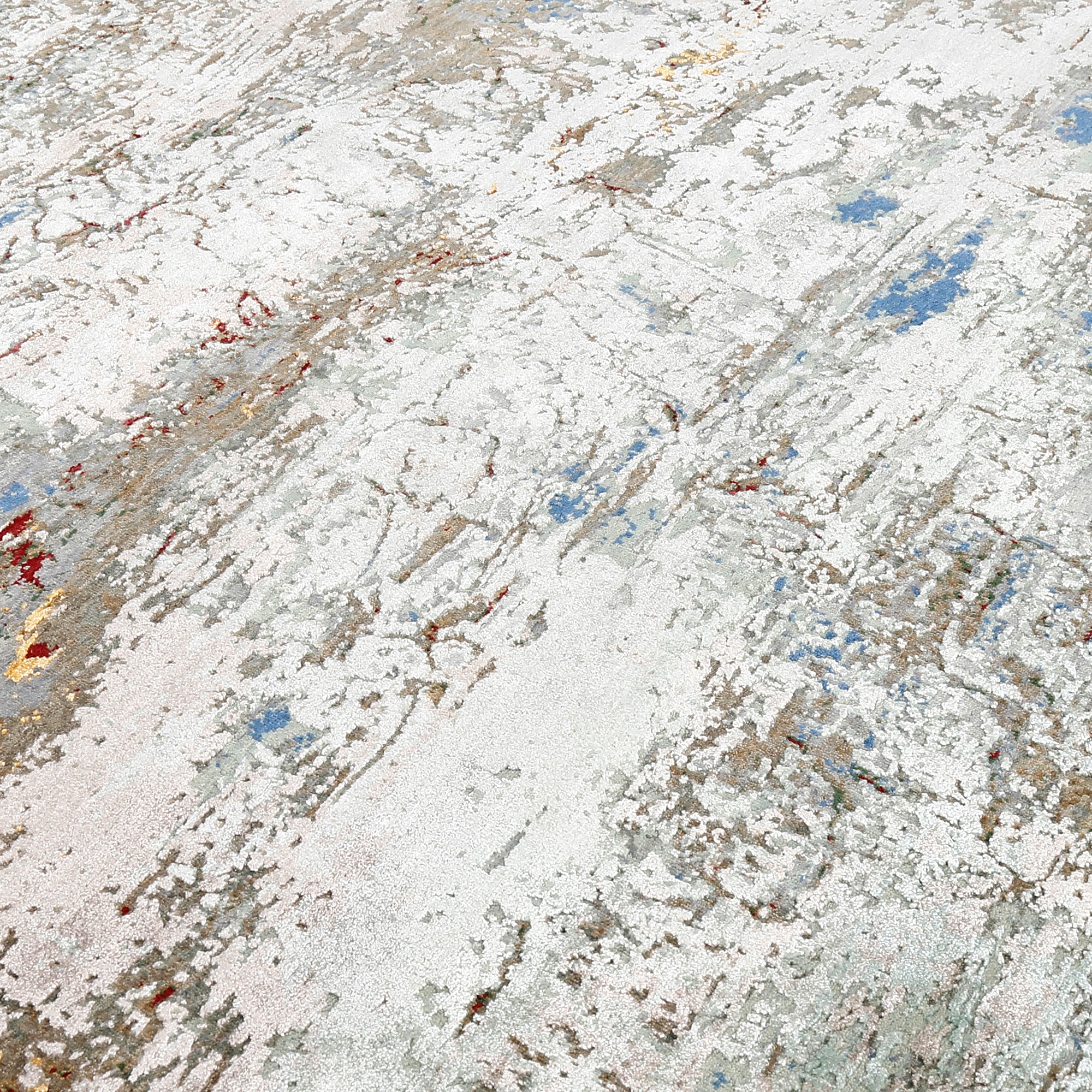 Close-up of the hand knotted wool and viscose texture with ivory beige blue and gold abstract detailing
