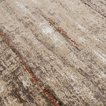 Close-up of the hand knotted wool and viscose texture with beige taupe brown and copper-rust abstract detailing