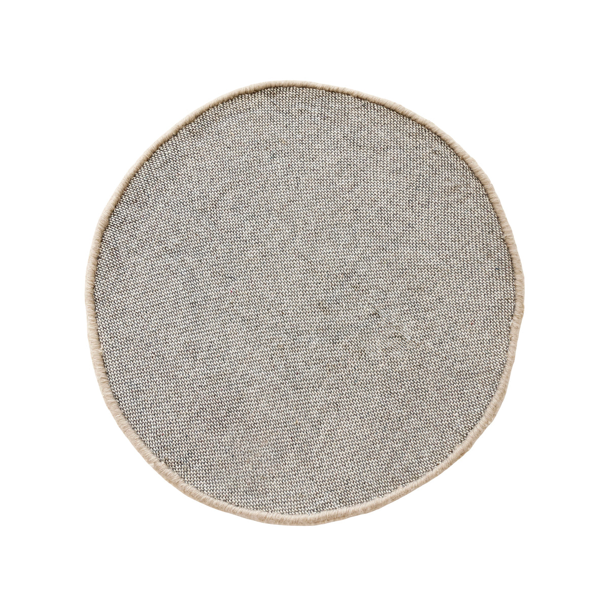 Side angle view of cream cheerful face wool kids rug showing its round shape, plush 12-15 mm hand tufted pile and playful cartoon design.