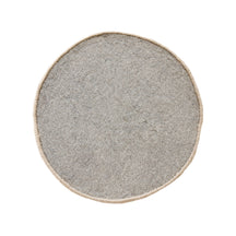 Side angle view of cream cheerful face wool kids rug showing its round shape, plush 12-15 mm hand tufted pile and playful cartoon design.