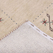 Corner and edge detail of cream Hand Woven Loom Lori wool rug showing zigzag border and handcrafted finishing