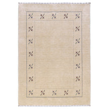 Full view of cream Hand Woven Loom Lori wool rug with multicolour floral motifs and delicate geometric border