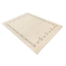 Side perspective of ivory Hand Woven Loom Lori wool rug highlighting natural wool texture and refined geometric tribal border design