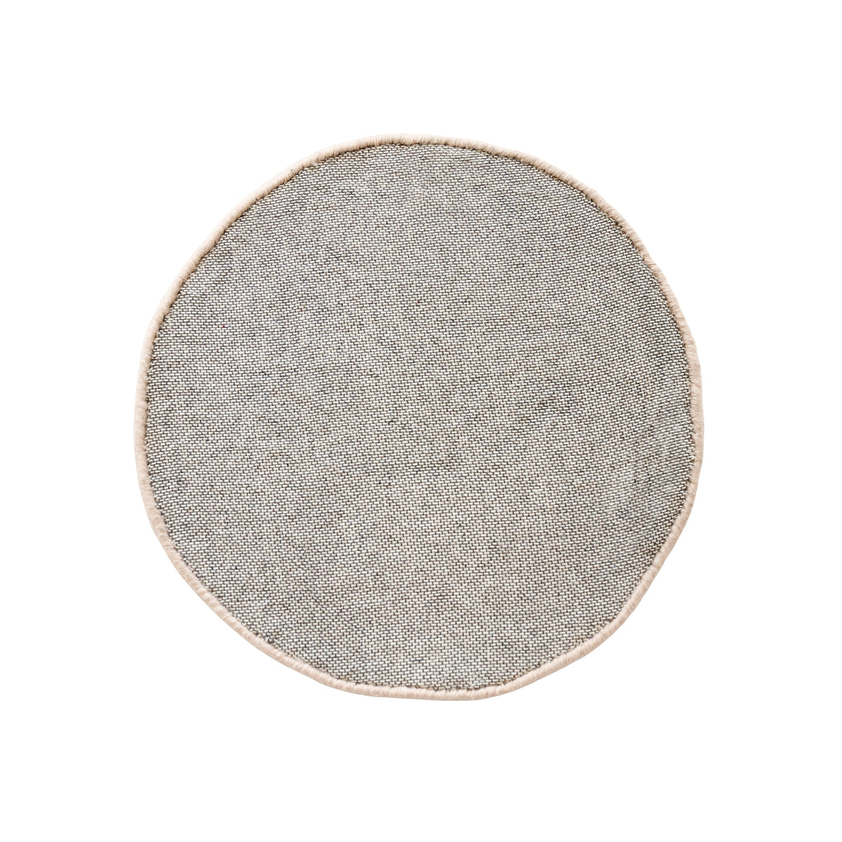Side angle view of cream smiling face wool kids rug showing its round shape, plush 12-15 mm hand tufted pile and playful cartoon design.