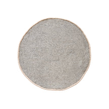 Side angle view of cream smiling face wool kids rug showing its round shape, plush 12-15 mm hand tufted pile and playful cartoon design.