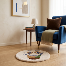 Cream smiling face hand tufted wool kids rug styled in a playful children’s bedroom with modern furniture and colourful decor.