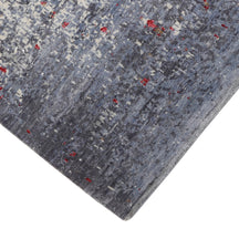 Hand-finished edge and softly distressed surface of the Crimson Mist hand knotted modern runner rug