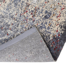 Hand-finished edge and softly distressed surface of the Crimson Mist hand knotted modern runner rug