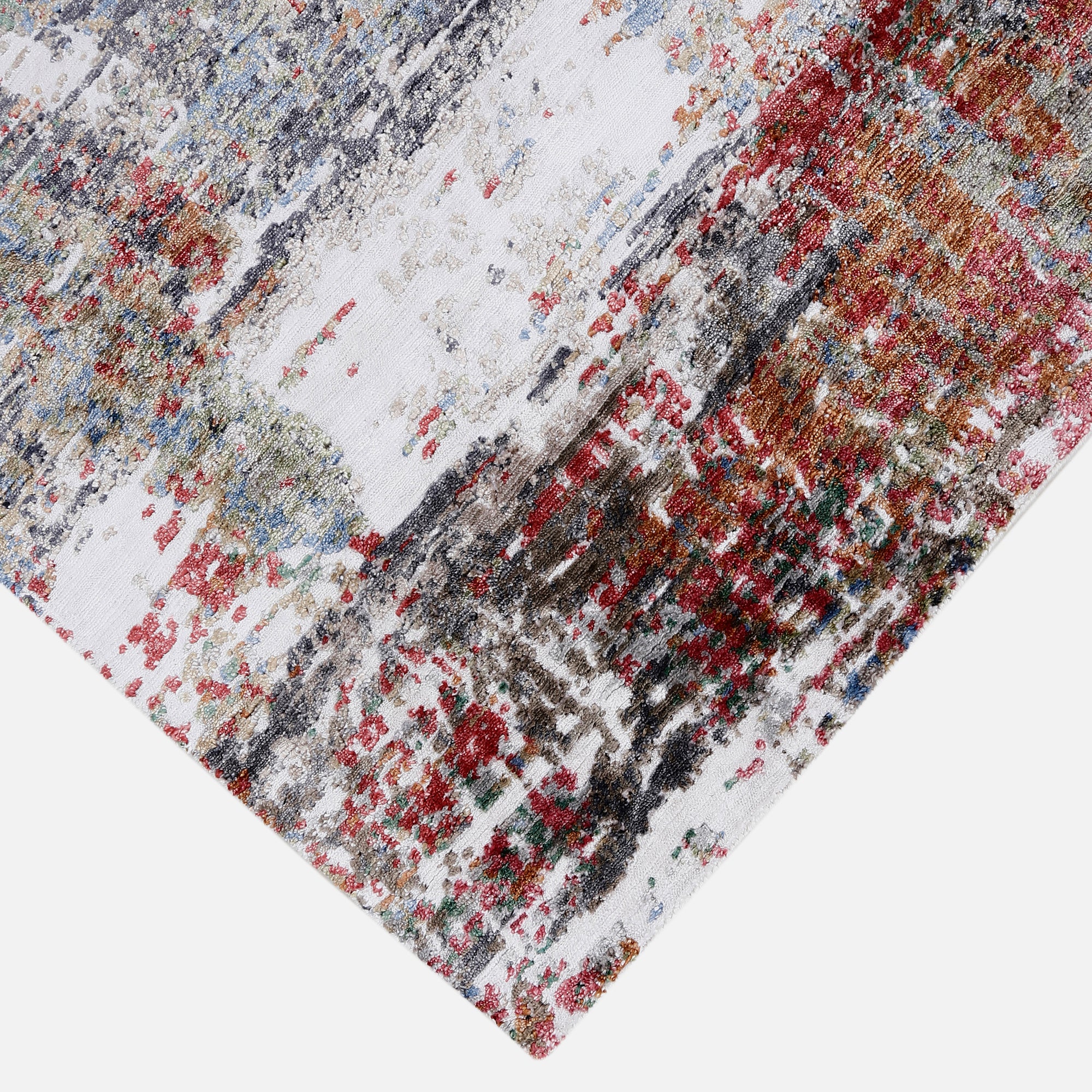Hand-finished edge and layered distressed surface of the Crimson Mist hand knotted viscose rug