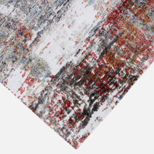 Hand-finished edge and layered distressed surface of the Crimson Mist hand knotted viscose rug