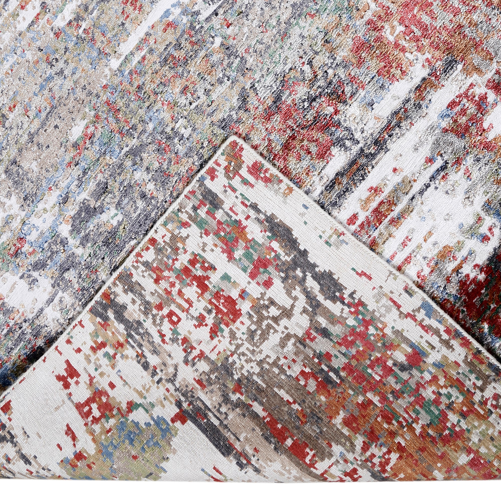 Hand-finished edge and layered distressed surface of the Crimson Mist hand knotted viscose rug