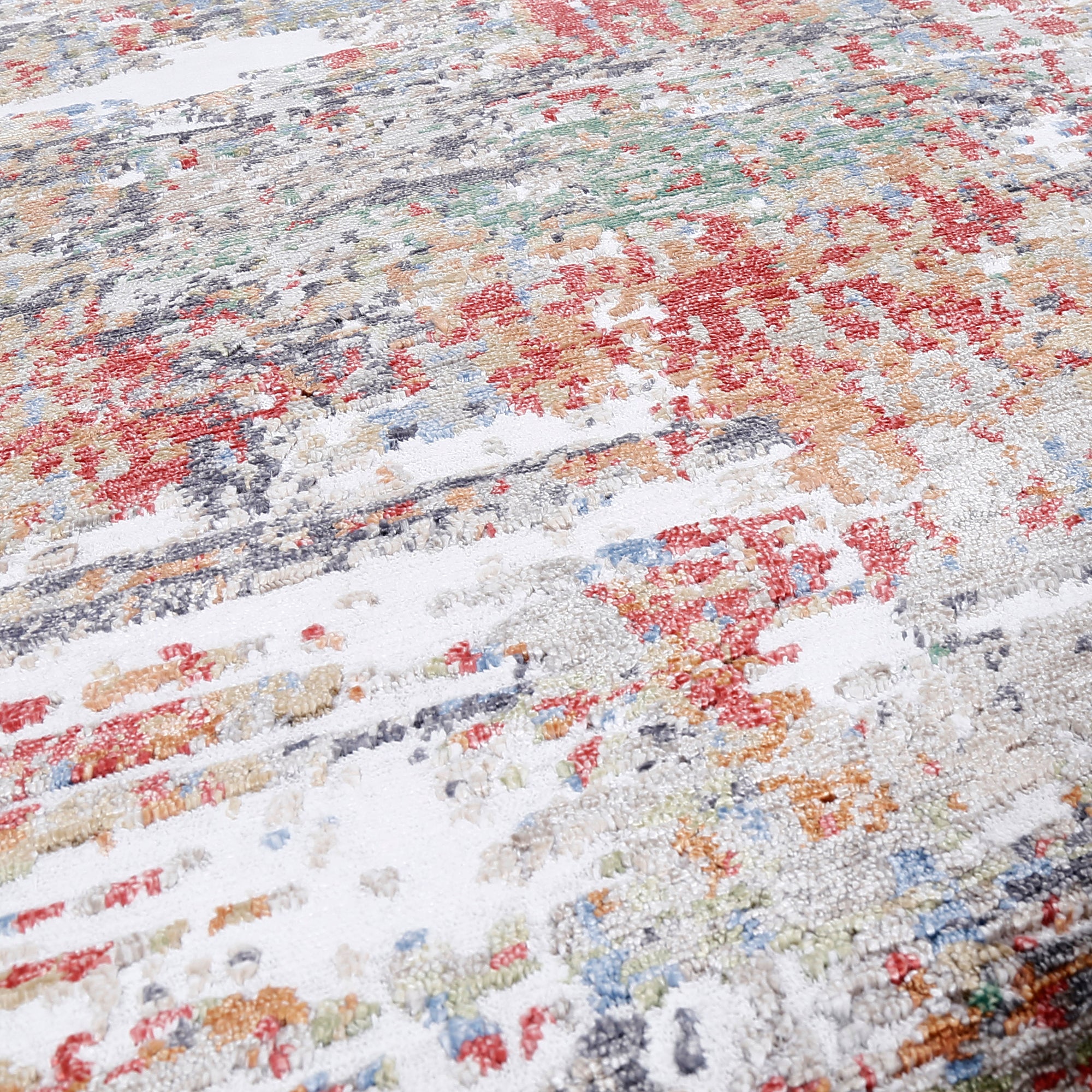 Close-up of Crimson Mist hand knotted viscose rug with ivory grey red rust and blue distressed detailing