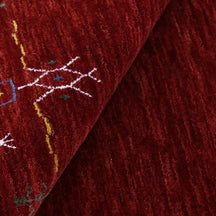 Close-up of deep red Hand Woven Loom Lori wool rug showing natural wool texture and detailed symbolic tribal motifs