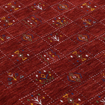 Close-up of crimson red Hand Woven Loom Lori wool rug showing dotted grid panels, diamond motifs and natural wool texture