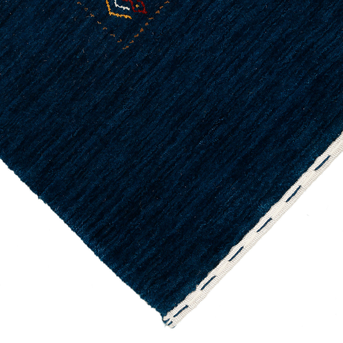 Corner and edge detail of deep navy blue Hand Woven Loom Lori wool rug showing handcrafted finish and natural wool texture