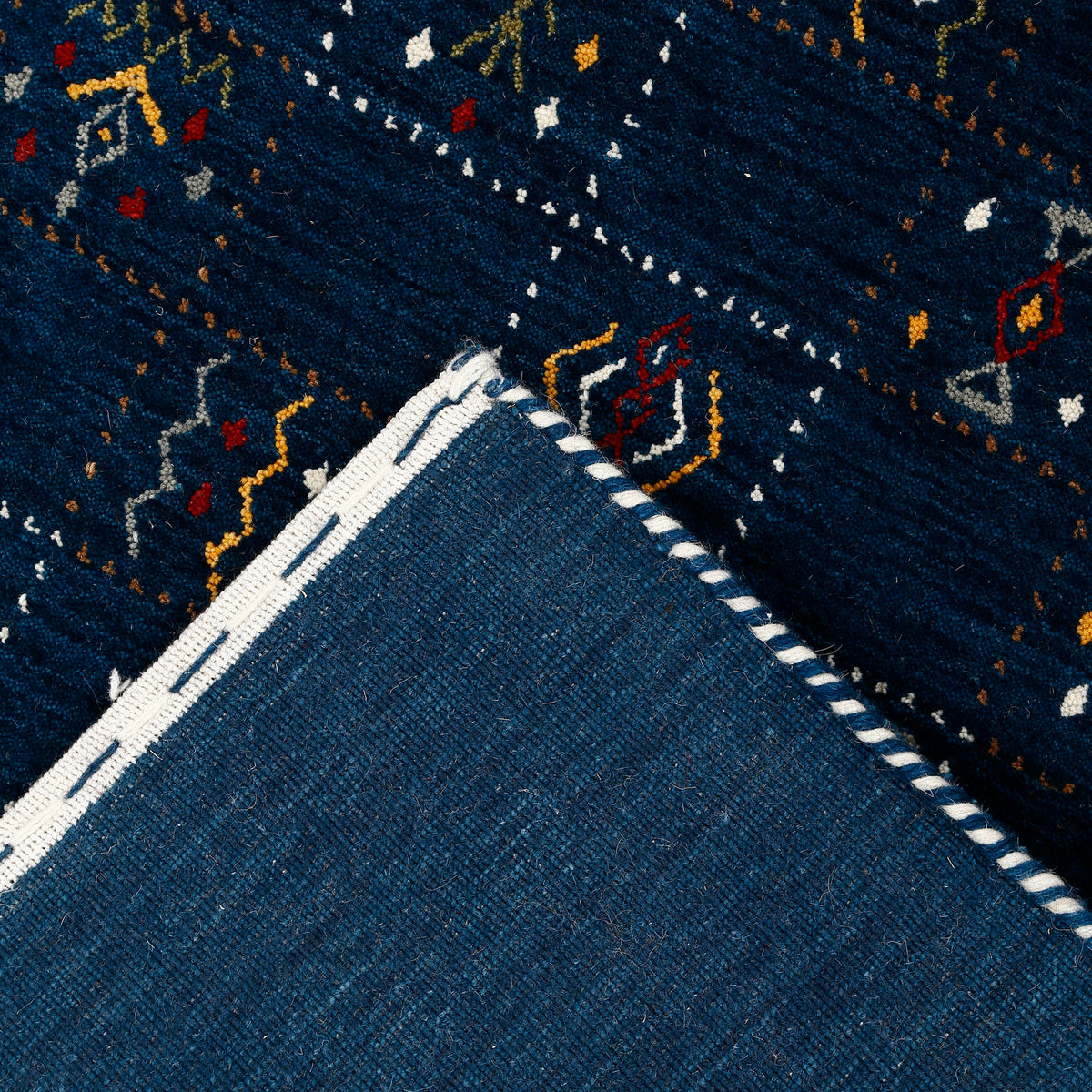 Corner and edge detail of deep navy blue Hand Woven Loom Lori wool rug showing handcrafted finish and natural wool texture