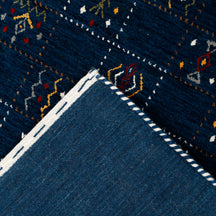 Corner and edge detail of deep navy blue Hand Woven Loom Lori wool rug showing handcrafted finish and natural wool texture