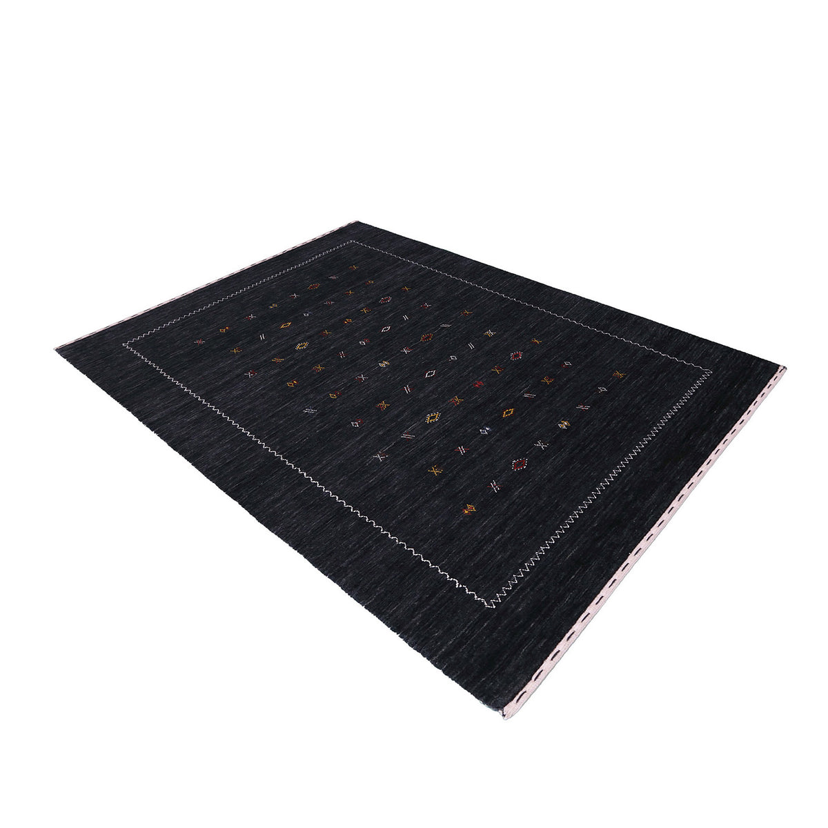 Side perspective of charcoal black Hand Woven Loom Lori wool rug highlighting natural texture, scattered motifs and ivory zigzag border design