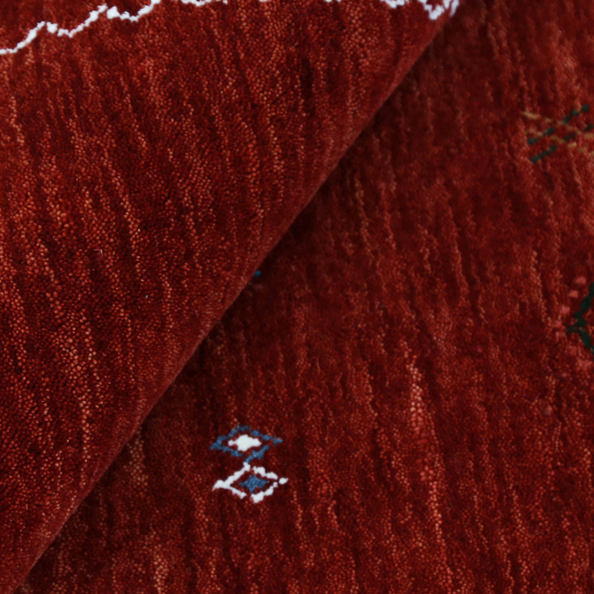 Close-up of crimson red Hand Woven Loom Lori wool rug showing natural wool texture and multicolour geometric tribal motifs