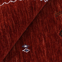 Close-up of crimson red Hand Woven Loom Lori wool rug showing natural wool texture and multicolour geometric tribal motifs