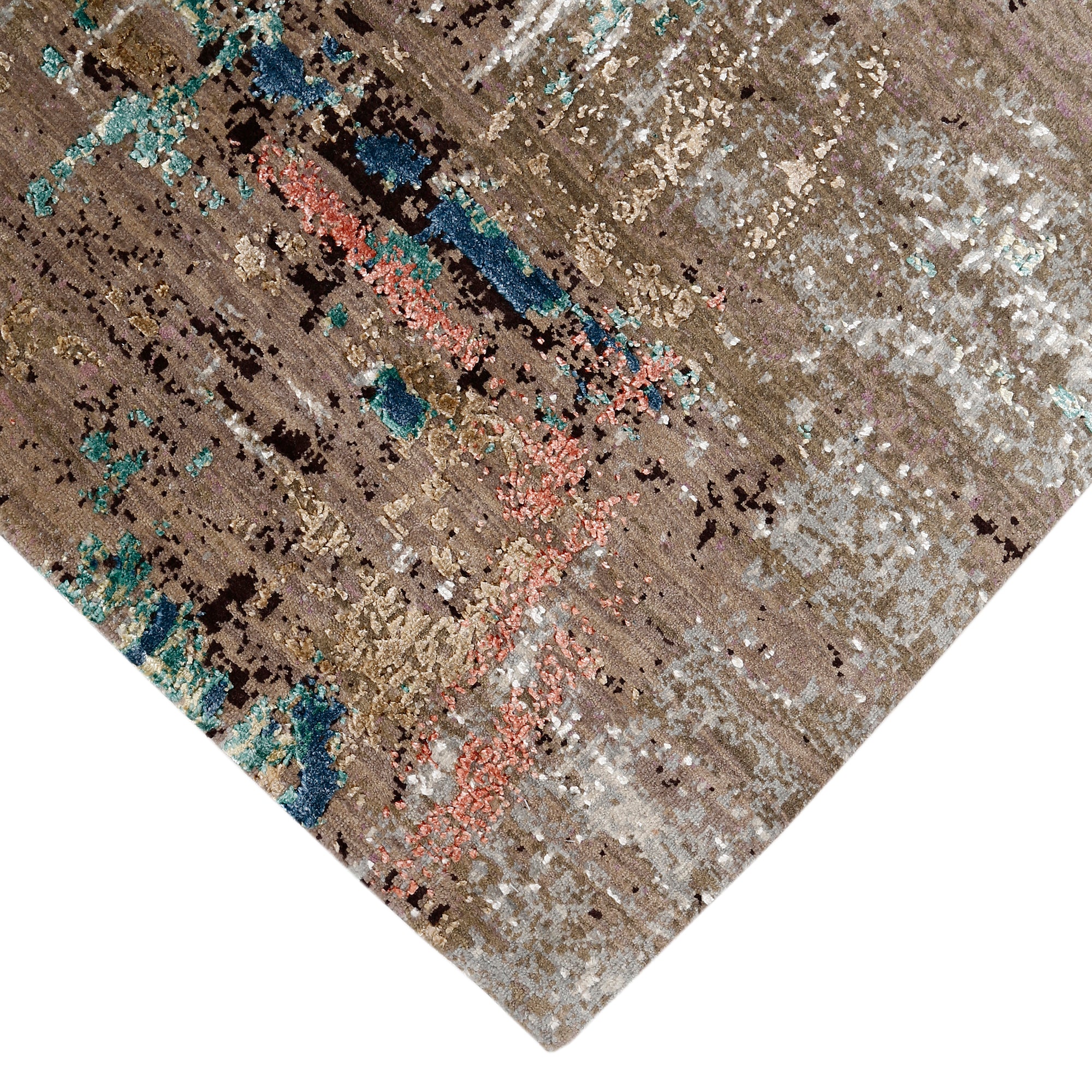 Hand-finished edge and layered distressed surface of the Desert Bloom hand knotted modern rug