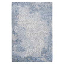 Frost blue distressed damask hand knotted wool and viscose rug with silver-grey ornamental detailing