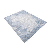 Frost blue distressed damask hand knotted wool and viscose rug with silver-grey ornamental detailing