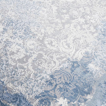 Close-up of the hand knotted wool and viscose texture with frost-blue distressed damask detailing
