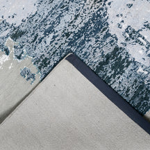 Hand-finished edge and textured abstract surface of the Frosted Echo hand knotted modern rug