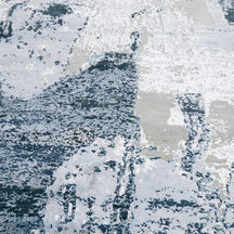 Close-up of the hand knotted wool and viscose texture with light grey ivory and blue abstract detailing