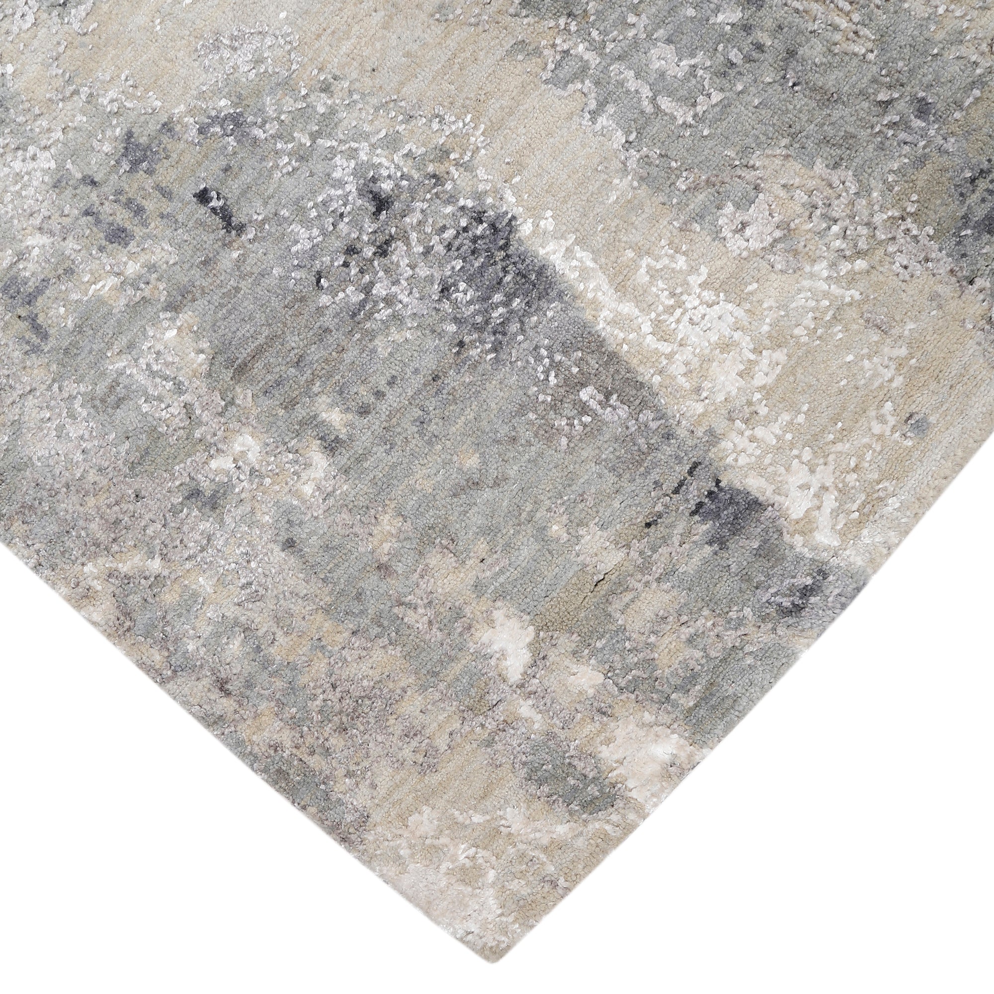 Hand-finished edge and softly distressed surface of the Glacier Whisper hand knotted modern rug