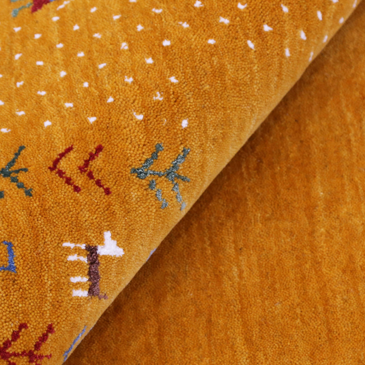 Close-up of golden mustard Hand Woven Loom Lori wool rug showing natural wool texture, botanical symbols and colourful tribal folk motifs