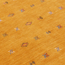 Close-up of golden mustard Hand Woven Loom Lori wool rug showing natural wool texture and multicolour geometric tribal motifs
