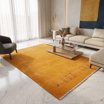 Golden mustard Hand Woven Loom Lori wool rug with ivory dotted folk border styled in a warm contemporary living room