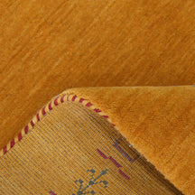 Close-up of golden mustard Hand Woven Loom Lori wool rug showing natural wool texture and intricate symbolic tribal detailing