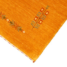 Corner and edge detail of golden ochre Hand Woven Loom Lori wool rug showing handcrafted finishing and geometric tribal detailing
