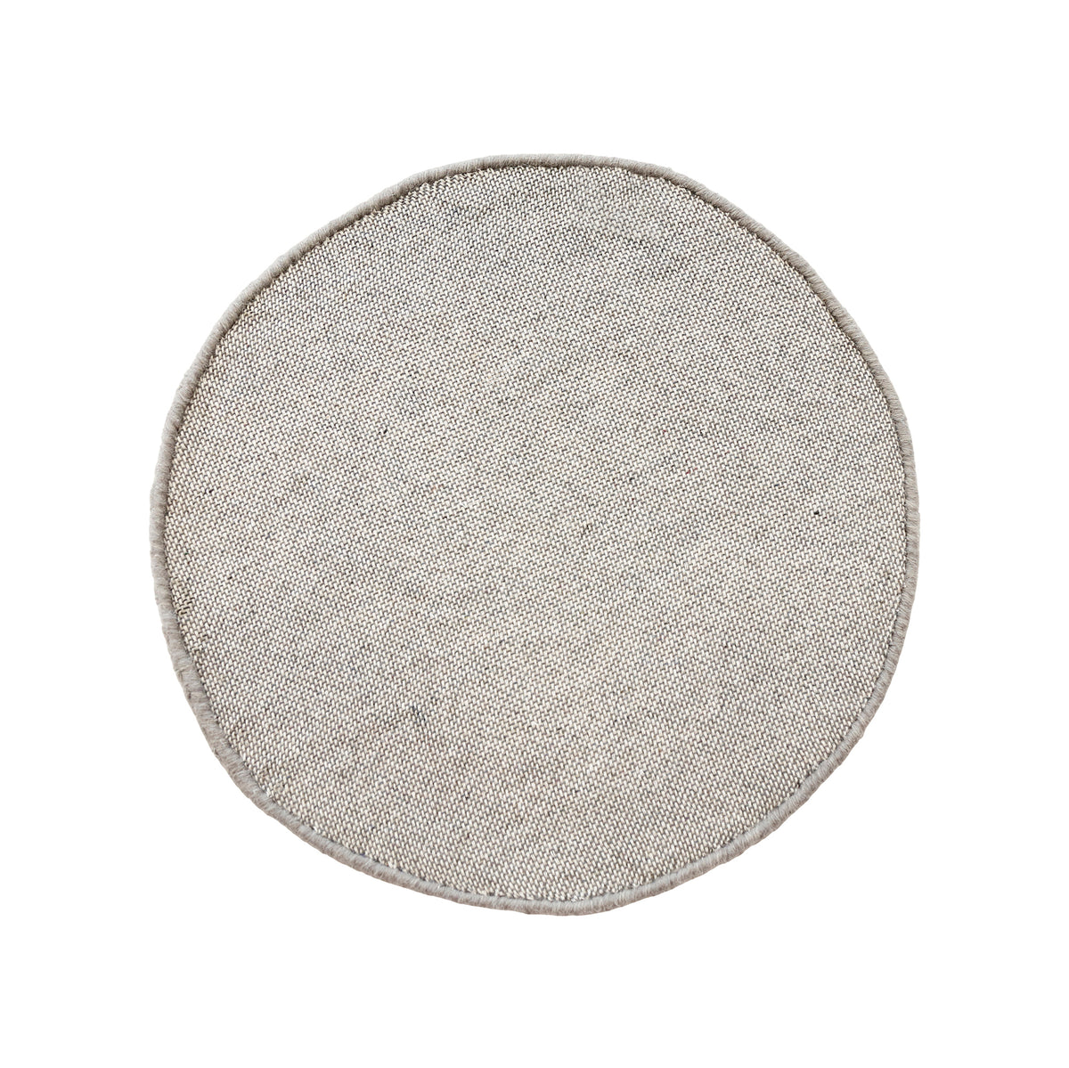 Side angle view of grey smiley face wool kids rug showing its round shape, plush 12-15 mm hand tufted pile and playful cartoon design.