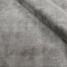 Close-up of grey Hand Woven Loom Lori wool rug with folded edge highlighting its soft 12–15 mm pile, smooth wool texture and subtle tonal surface variations.