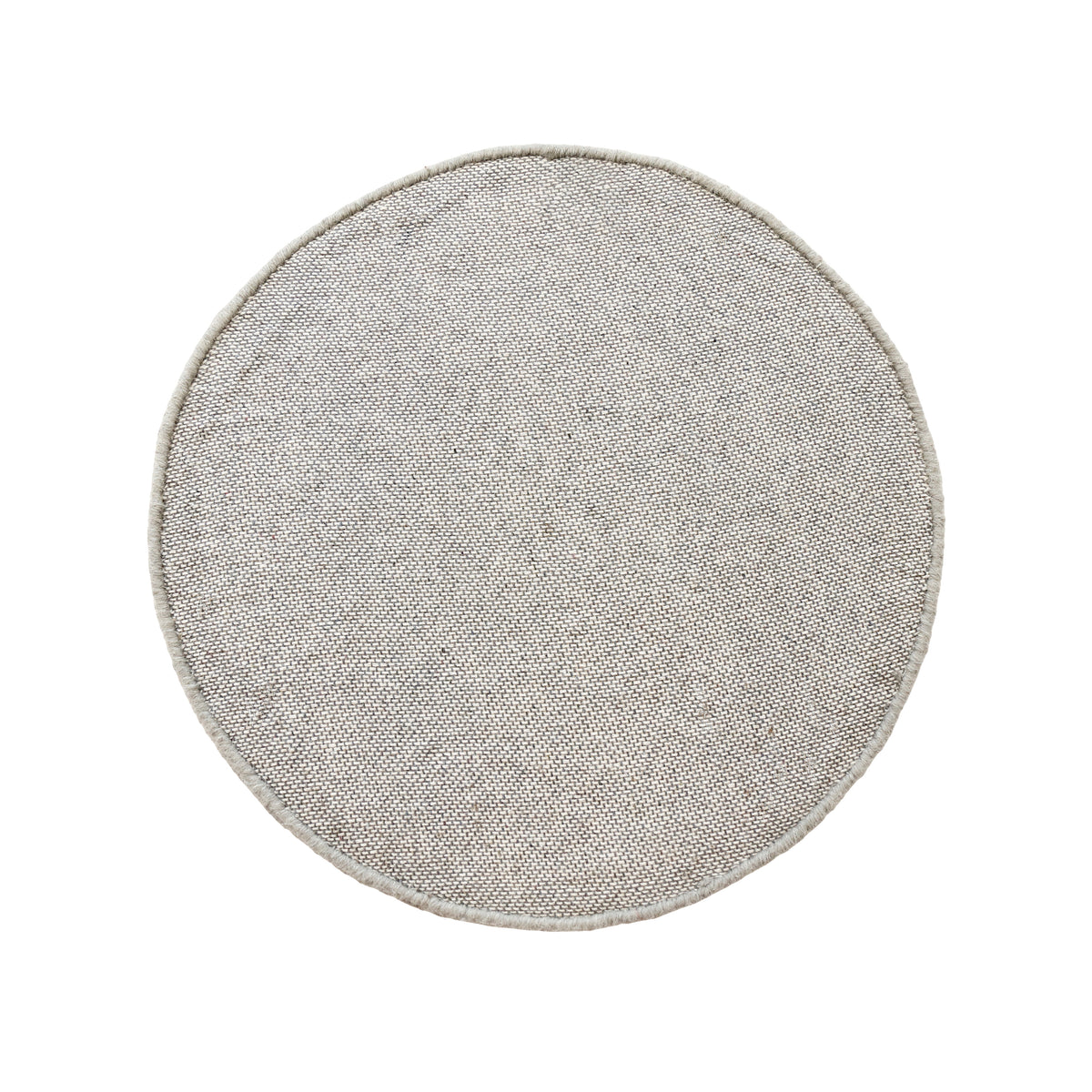 Side angle view of grey smiley face wool kids rug showing its round shape, plush 12-15 mm hand tufted pile and playful cartoon design.