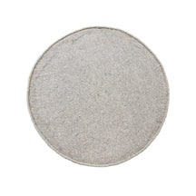 Side angle view of grey smiley face wool kids rug showing its round shape, plush 12-15 mm hand tufted pile and playful cartoon design.