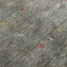 Close-up of slate grey Hand Woven Loom Lori wool rug showing natural wool texture and multicolour tribal geometric motifs