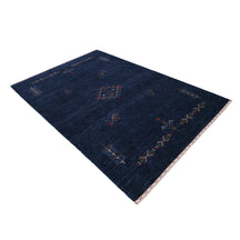 Side perspective of deep navy blue Hand Woven Loom Lori wool rug highlighting handcrafted texture and central tribal medallion design