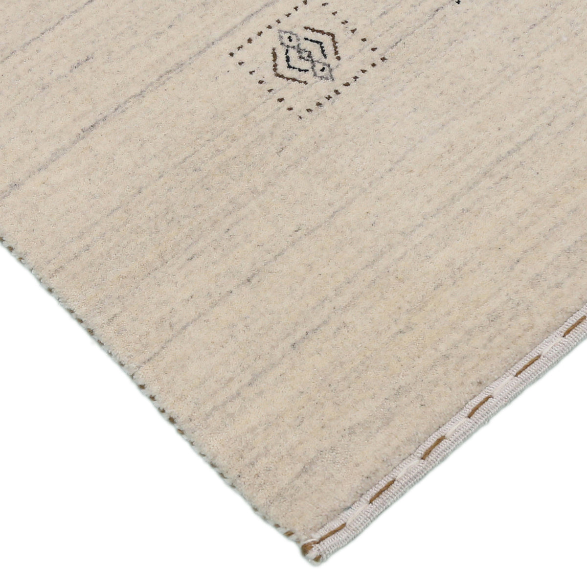 Corner and edge detail of ivory beige Hand Woven Loom Lori wool rug showing natural wool texture and handcrafted finishing