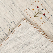 Corner and edge detail of ivory cream Hand Woven Loom Lori wool rug showing natural wool texture and handcrafted finishing